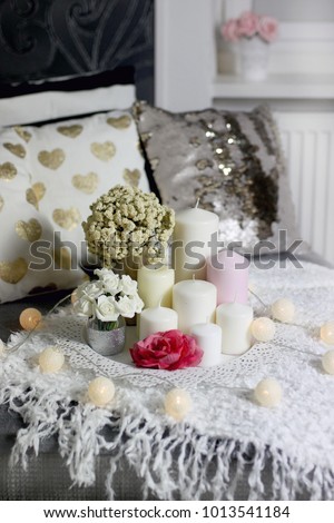 Image of romantic coffee table centerpiece for valentine´s day, wedding or anniversary with flowers, pillar candles and decorative white tray