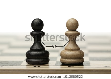 A pair of enemies reconciles and shakes hands at a meeting. Made from chess pawns Royalty-Free Stock Photo #1013580523