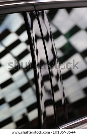 Close up view of the shadow of a decorative exterior wall a on a car. Pattern composed with rectangular thin bricks suspended with steel cables. Geometric urban background. Modern graphic design.