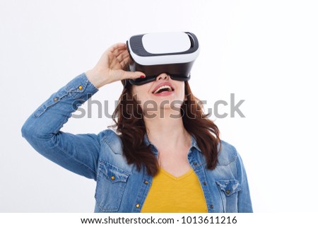 Woman wearing VR headset and looking up in virtual reality isolate on white background. Computer technology. Copy space and mock up.