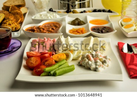 Traditional Turkish Breakfast Plate with tea and boiled egg on the white table.Close up taken