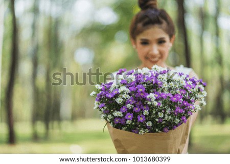 Beautiful young happy woman holding a beautiful bouquet.	