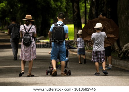 Asian family strolling in the gardens of the Royal Palace of the Imperial City of Hue, Vietnam