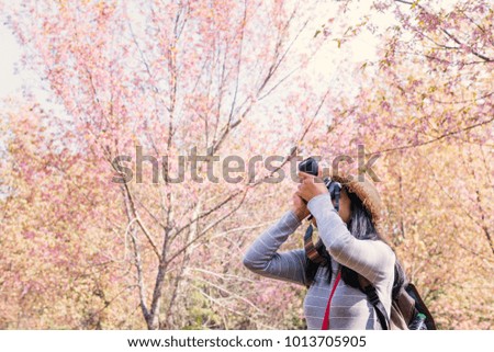 Asian tourist shooting picture in nature , Relax time on holiday concept travel,selective and soft focus,tone of hipster style