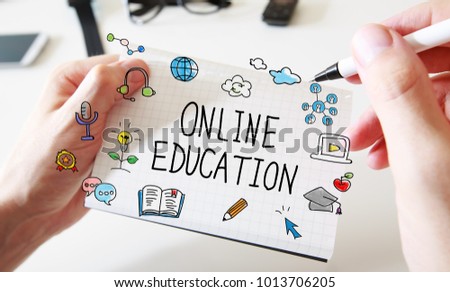 Online Education with mans hands and a white notebook