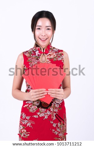 Beautiful smilling Chinese woman is holding red packet of Ang Pao present of Chinese New Year. given during holidays or special occasions. 