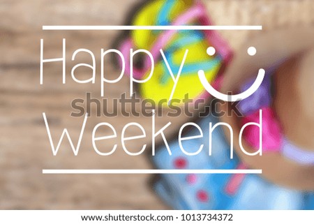 Happy Weekend text on blur photo of beach accessories on old wooden background