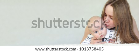 baby and mom on a white background. horizontal sheet orientation