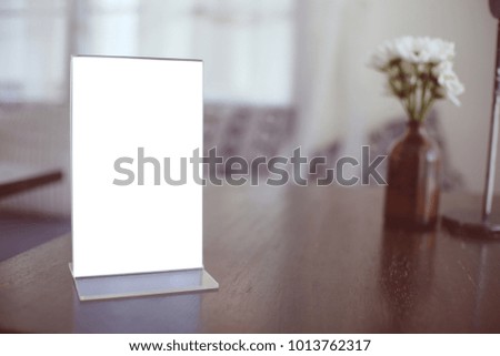 frame standing on wood table in Bar restaurant cafe. space for text marketing promotion