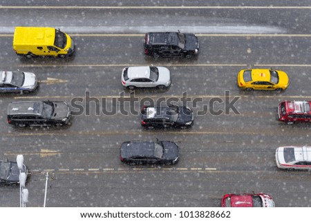 View from above of cars on the road in snowy day in the city