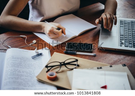 A girl writing in a notebook. Creativity, art and education concept Royalty-Free Stock Photo #1013841808
