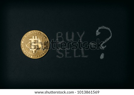 Golden bitcoin coin - symbol of cryptocurrency and words BUY or SELL, toned