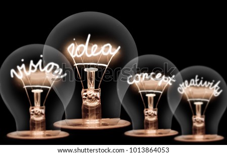 Photo of light bulbs with shining fibres in IDEA, VISION, CONCEPT and CREATIVITY shape on black background Royalty-Free Stock Photo #1013864053