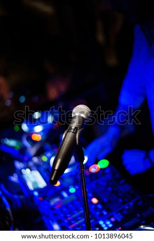 DJ playing music and microphone ready for the artist to start singing at his show