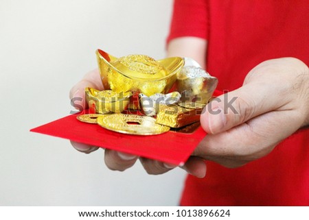 Hands give Gold and silver and red envelope "Ang Pao".