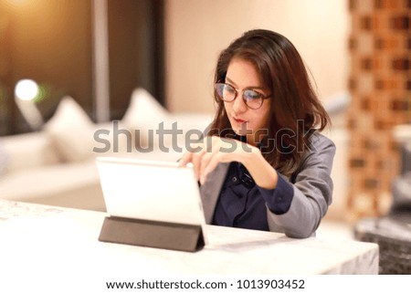 beautiful businesswoman portrait with glasses using tablet (this image for business and technology background concept)
