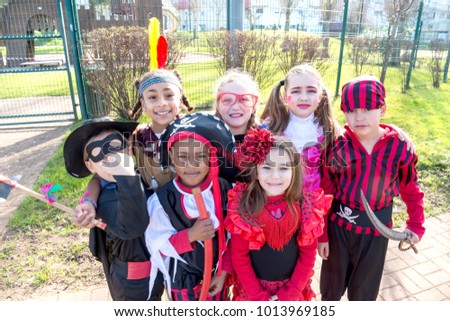 Group of kids in Halloween costumes in a park