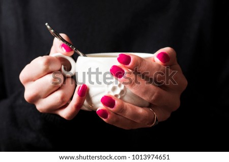 Female holding a cup of tea close up