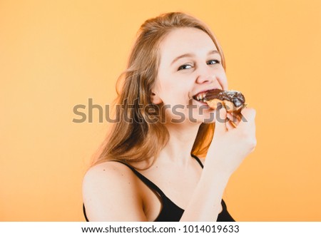 portrait of cute smiling Caucasian blond woman with pastries in her hands