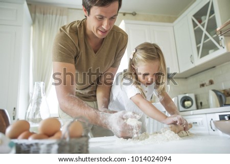 The family cooks in the kitchen