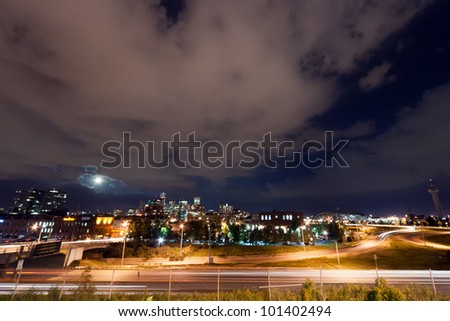 Denver skyline with the full moon rising at night