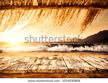 Table background with free space for your decoration of product or text and summer landscape of sea and beach. 