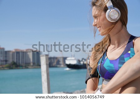 Roller skater relaxing and listening to music with headphones