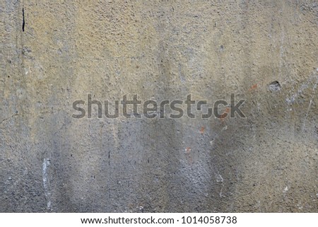A close-up shot of an old white-painted concrete wall with mold stains as abstract background