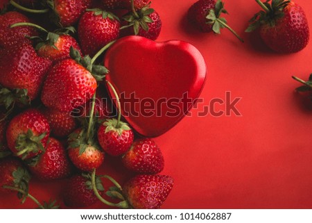 Valentine red heart and strawberry on red background