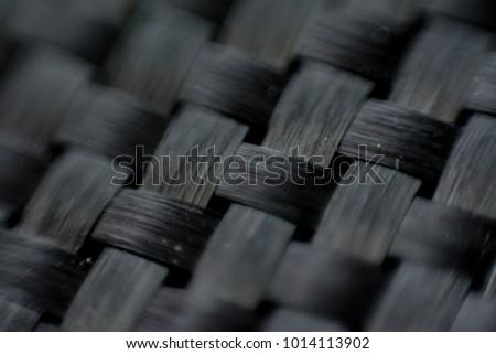 Black carbon fiber composite close up macro view