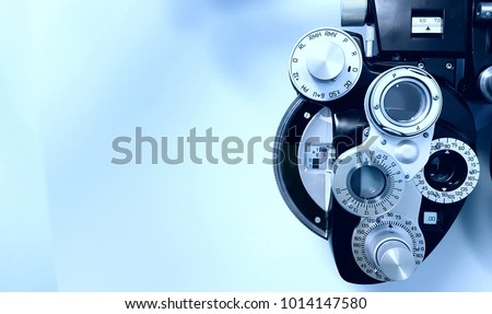 Front view of blue phoropter with blue background Royalty-Free Stock Photo #1014147580