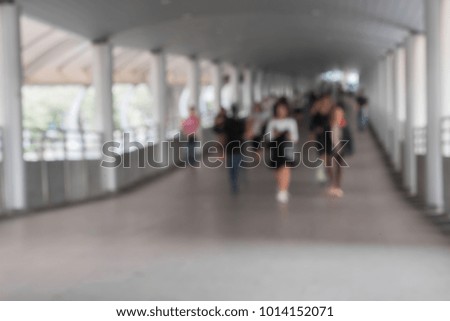 Motion blurred and out of focus. People crowd walking on walkway site at rush hour time in the city street. Concept of lifestyle transportation.