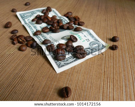 Coffee bean on one dollar banknote on the wooden background macro