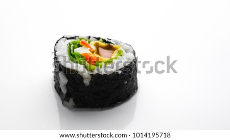 Sushi is the Japanese preparation and serving of specially prepared vinegared rice combined with varied ingredients such as seafood, vegetables, and tropical fruits. Selective Focus.