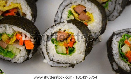 Sushi is the Japanese preparation and serving of specially prepared vinegared rice combined with varied ingredients such as seafood, vegetables, and tropical fruits. Selective Focus.