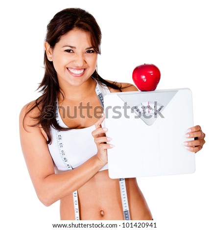 Healthy eating woman on a diet holding a scale - isolated over a white background