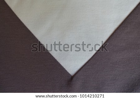 Light beige triangular gusset sewn to brown fabric