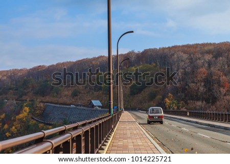 View road and colorful mountain of Jogakura bridge in Autumn season, Aomori, Japan