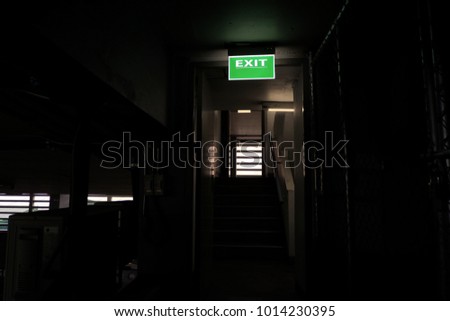 Green emergency exit light sign at Fire escape staircase
