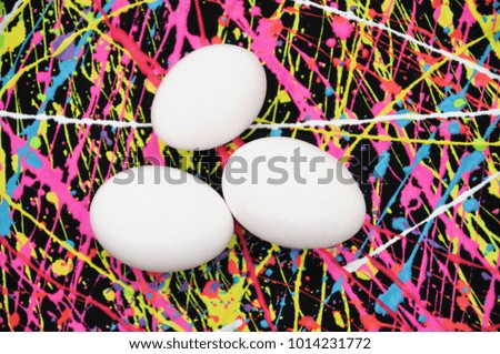 Easter eggs on an neon splash abstract background. 