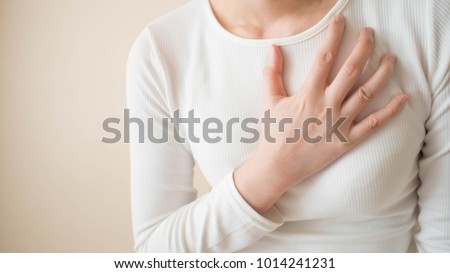 Acid reflux or Gastroesophageal reflux disease (GERD) concept. Young female suffering from heartburn or chest discomfort symptoms. Health care and medical concept. Close up. Copy space. Royalty-Free Stock Photo #1014241231