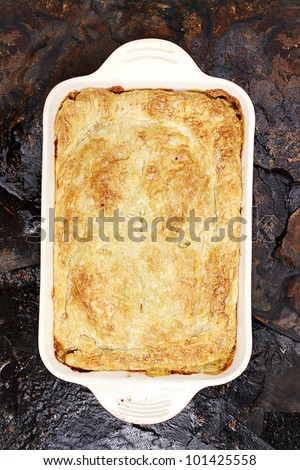 Above view of fresh Chicken Pot Pie over a rustic background.