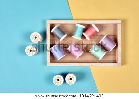 Pastel  color background, Thread rolls, Group of colorful thread on sewing desk, Craft, sewing and needlework concept.