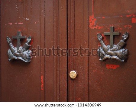 Italian wooden entrance. Rectory door, religious symbols. 