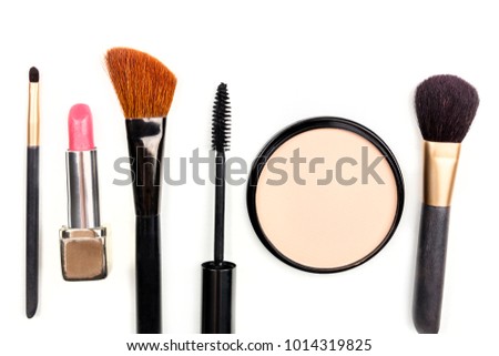 Makeup brushes, powder, lipstick, and a mascara applicator, shot from above on a white background with copy space. A template for a makeup artist's business card or flyer design