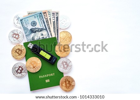 Green passport, on white background, identity confirmation. Memory card USB stick purse. US dollars USD, metal coins gold bitcoin, crypto currency,  identification. Security code of a cold wal