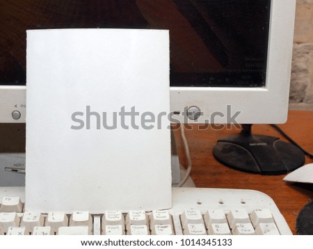 Blank white paper sticker on desktop computer monitor close up