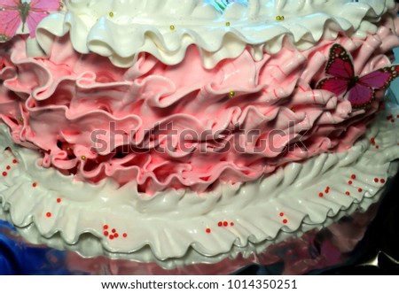 cake side is decorated with ruffles of cream you can use for the background