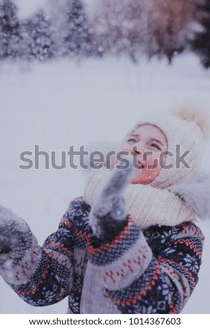 girl playing with snowball