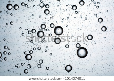 blue background of drops of oil on water